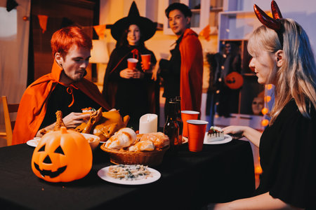 Friends enjoying a Halloween party at a bar making a toast