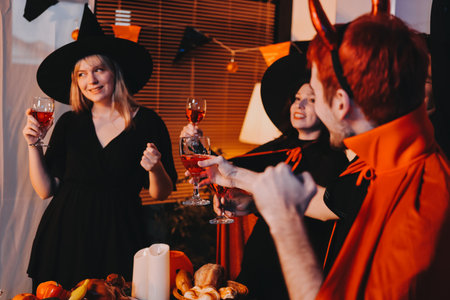 Friends enjoying a Halloween party making a toastの写真素材