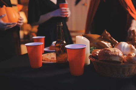 Friends enjoying a Halloween party at a bar making a toastの写真素材