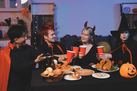 Friends enjoying a Halloween party at a bar making a toastの写真素材