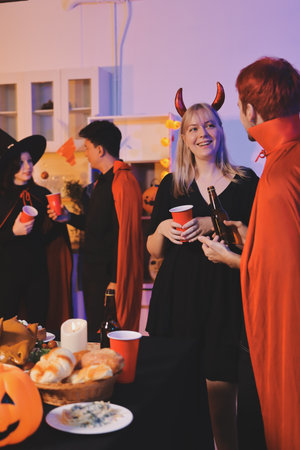 Friends enjoying a Halloween party at a bar making a toastの写真素材
