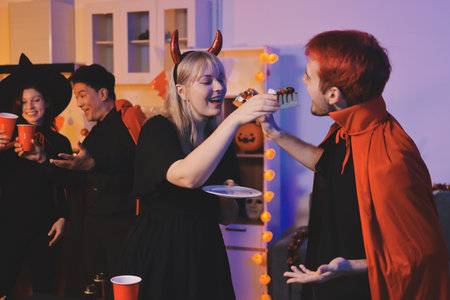 Friends enjoying a Halloween party at a bar making a toast