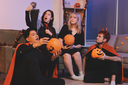 Friends enjoying a Halloween party making a toastの写真素材