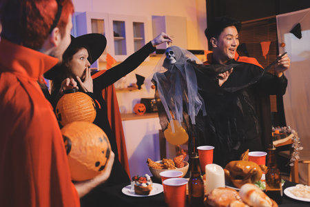 Friends enjoying a Halloween party at a bar making a toastの写真素材