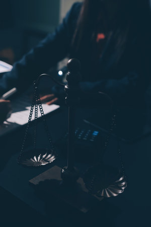 Consultation and conference of professional businesswoman and male lawyers working and discussion having at law firm in office. Concepts of law, gavel with scales of justiceの写真素材