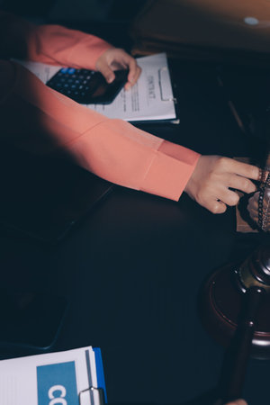 Consultation and conference of professional businesswoman and Male lawyers working and discussion having at law firm in office. Concepts of law, Judge gavel with scales of justiceの写真素材