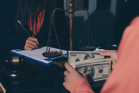 Consultation and conference of professional businesswoman and Male lawyers working and discussion having at law firm in office. Concepts of law, Judge gavel with scales of justiceの写真素材