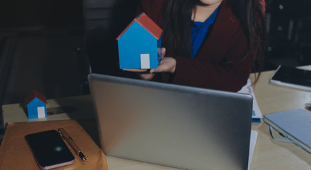 Customer signing a real estate contract in real estate agency.