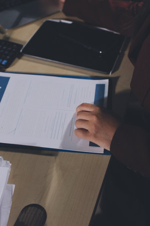 Customer signing a real estate contract in real estate agency.