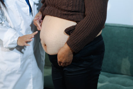cropped shot of doctor examining pregnant woman during medical consultationの写真素材