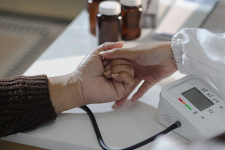 A doctor's hands carefully taking a patient's blood pressure using a sphygmomanometer.