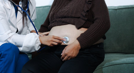 cropped shot of doctor examining pregnant woman during medical consultation