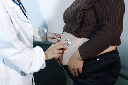 cropped shot of doctor examining pregnant woman during medical consultationの写真素材