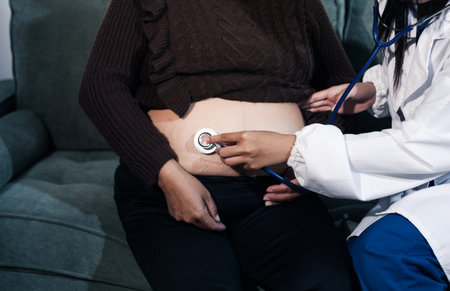 cropped shot of doctor examining pregnant woman during medical consultation