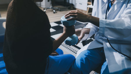 Unrecognizable person uses blue hand weight during physical therapy session