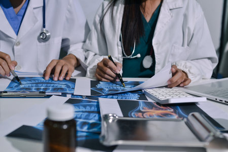 Doctor Explaining X-Ray Results to a Patient Using a Digital Deviceの写真素材
