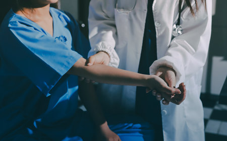 Doctor examining patient's elbow in hospital room