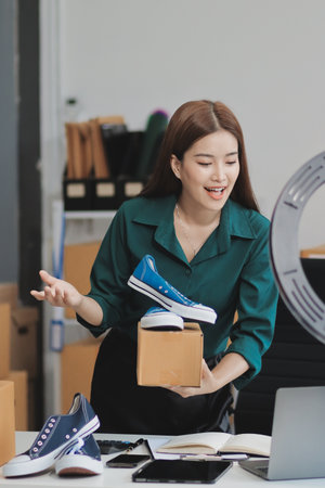 Starting small businesses SME owners female entrepreneurs check online orders to prepare to pack the boxes, sell to customers, sme business ideas online.の写真素材