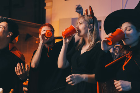 Friends enjoying a Halloween party at a bar making a toast