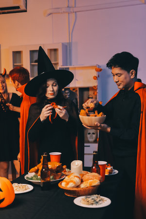 Friends enjoying a Halloween party at a bar making a toastの写真素材