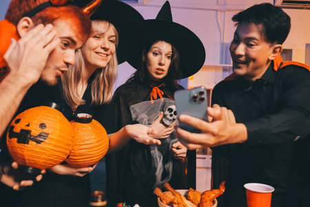 Friends enjoying a Halloween party at a bar making a toastの写真素材