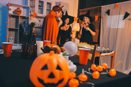 Friends enjoying a Halloween party making a toastの写真素材
