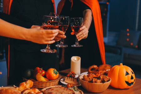 Friends enjoying a Halloween party at a bar making a toastの写真素材