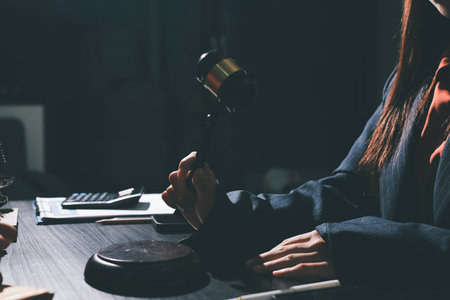 Consultation and conference of professional businesswoman and Male lawyers working and discussion having at law firm in office. Concepts of law, Judge gavel with scales of justiceの写真素材