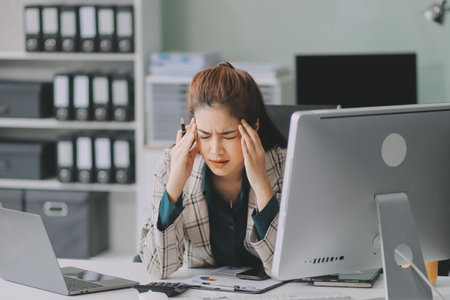 Pain, headache and stressed finance manager feeling sick, tired and worried about a financial...