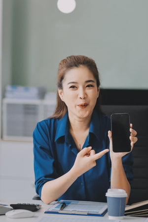 Young Asian businesswoman giving presentationの写真素材