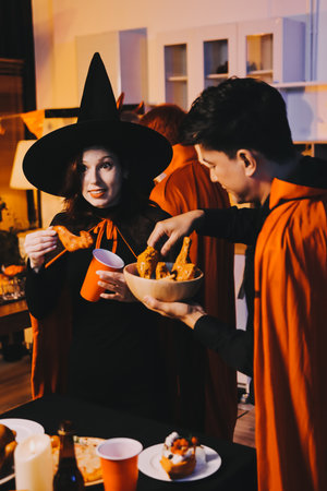 Friends enjoying a Halloween party making a toastの写真素材