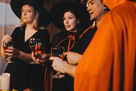 Friends enjoying a Halloween party making a toast