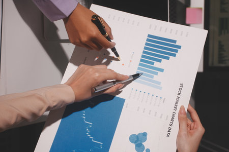 Above table with finance papers, graphs and big data during teamwork meeting with accounting or...