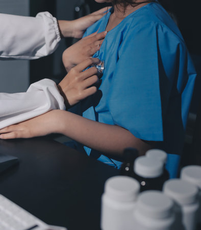 healthy concept; Doctor checking patient's heart with stethoscope at a hospital