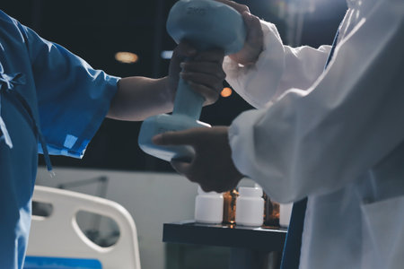 Physical therapist assisting a woman with dumbbell exercise