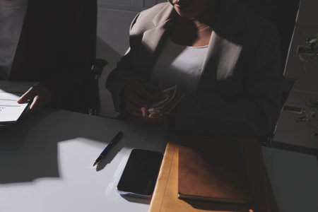 Judge gavel with Justice lawyers having team meeting at law firm in background. Notary with client in officeの写真素材