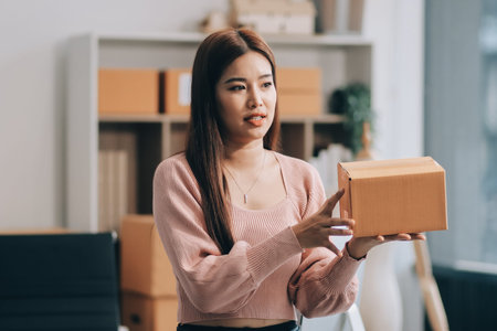 Starting small businesses SME owners female entrepreneurs check online orders to prepare to pack the...