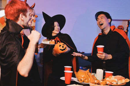Friends enjoying a Halloween party at a bar making a toastの写真素材