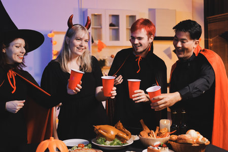 Friends enjoying a Halloween party making a toast