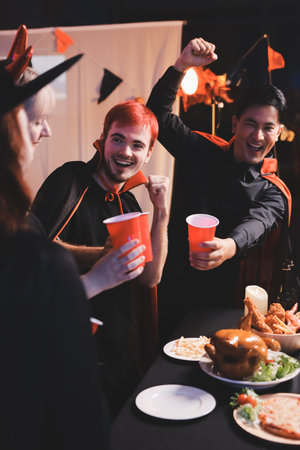 Friends enjoying a Halloween party at a barの写真素材