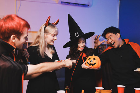 Friends enjoying a Halloween party making a toastの写真素材
