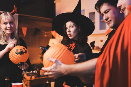 Friends enjoying a Halloween party at a bar making a toastの写真素材