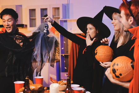 Friends enjoying a Halloween party at a bar making a toast