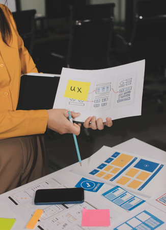 team of UI UX web designer are working together to develop mobile responsive websites with UI UX...