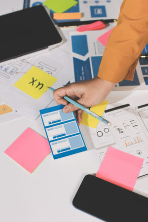 team of UI UX web designer are working together to develop mobile responsive websites with UI UX...