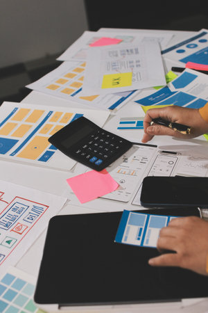 team of UI UX web designer are working together to develop mobile responsive websites with UI UX...
