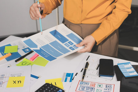 team of UI UX web designer are working together to develop mobile responsive websites with UI UX...