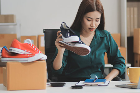 Starting small businesses SME owners female entrepreneurs check online orders to prepare to pack the boxes, sell to customers, sme business ideas online.の写真素材