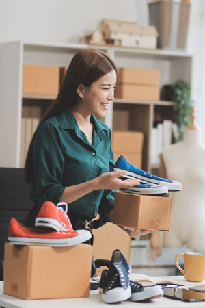Starting small businesses SME owners female entrepreneurs check online orders to prepare to pack the boxes, sell to customers, sme business ideas online.の写真素材