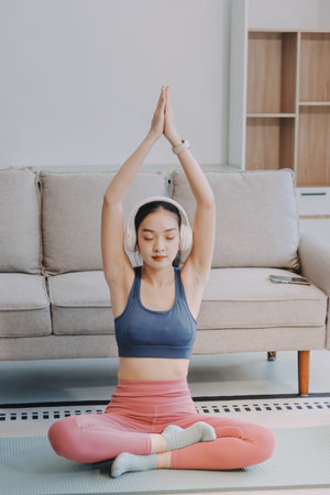 Young Asian people practicing yoga lesson with instructor. Asia group of women exercising healthy lifestyle in fitness studio. Sport activity, gymnastics or ballet dancing class.の写真素材